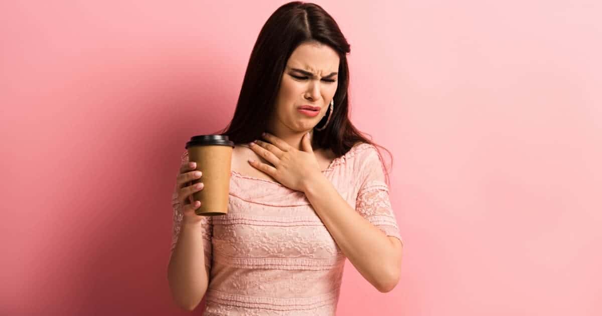 woman with disgusted look after drinking coffee