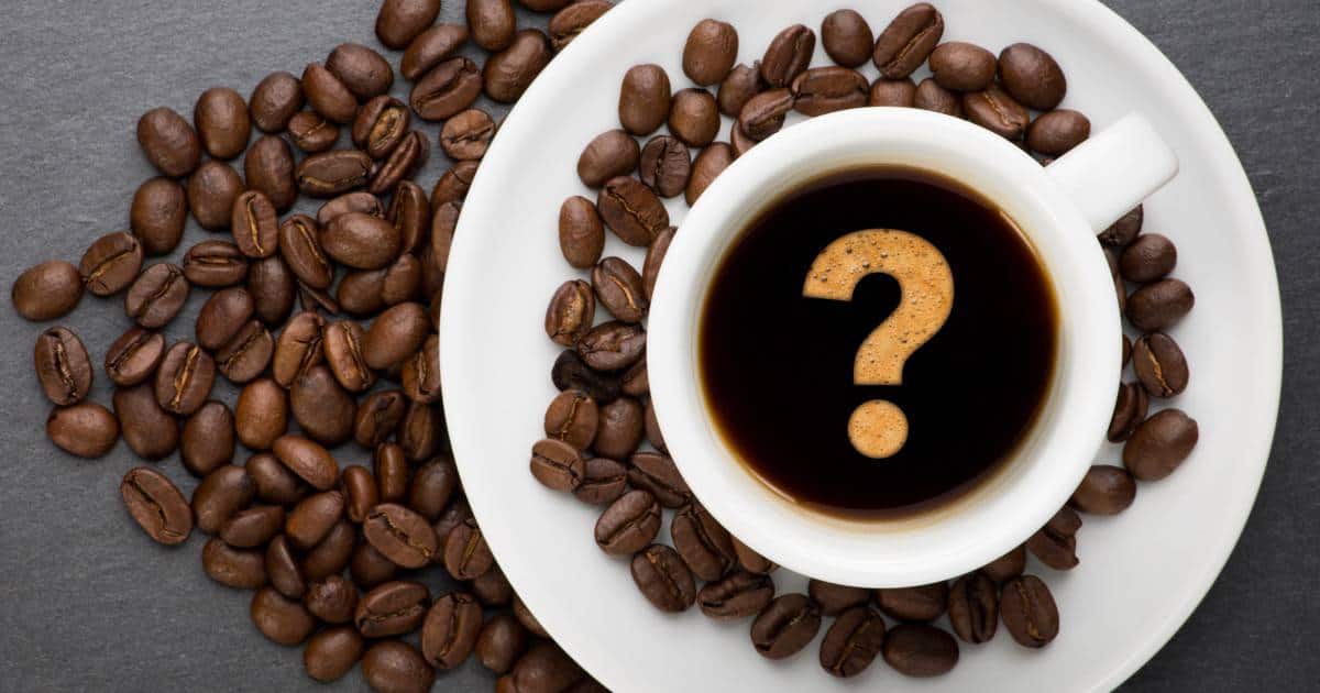 coffee beans around a coffee cup with a question mark